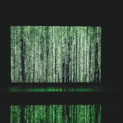 Abstract depiction of green matrix code on a computer monitor.
